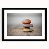 Framed wall art featuring a stunning landscape design with rocks, set in a sleek black frame with a white mat, ideal for modern home decor.