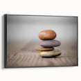 Framed canvas wall art showcasing a serene landscape with rocky formations, featuring a sleek black frame and side view that highlights its elegant design for modern decor.