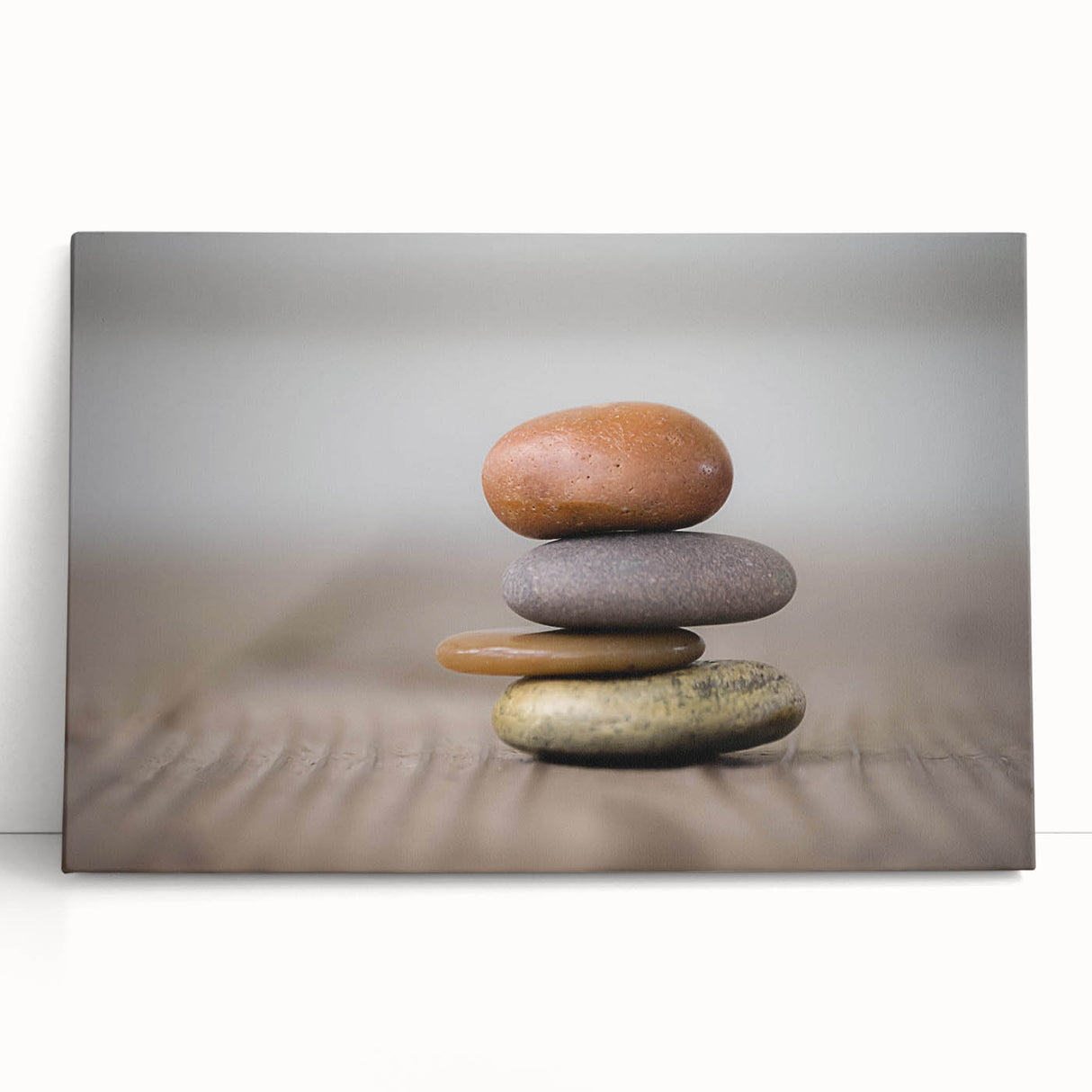 Stretched canvas wall art featuring a vibrant landscape design with rocky formations and a soothing color palette, perfect for home decor. The artwork leans against a neutral backdrop, showcasing its artistic details and textures, ideal for nature enthusiasts.