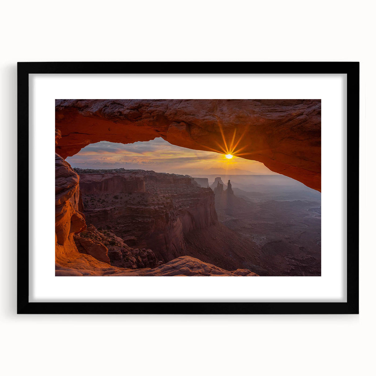 Framed wall art featuring a stunning landscape of rocky formations, presented in a sleek black frame with a mat, ideal for modern home decor.