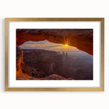 Framed wall art featuring a vibrant landscape design with rocky formations and soft pastel colors, elegantly displayed with a gold mat for a luxurious touch.