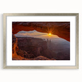 Framed wall art featuring a serene landscape with rocks and natural elements, presented in a silver frame with a white mat, perfect for home decor enhancement.