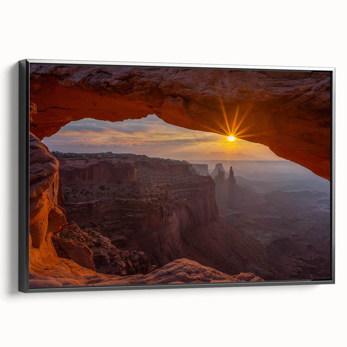 Framed canvas wall art showcasing a contemporary rock landscape design in earthy tones, featuring a sleek black frame, perfect for modern home decor.
