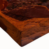 Close-up of a stretched canvas featuring a vibrant landscape design with textured rocks and earthy tones, ideal for modern home decor and art enthusiasts.