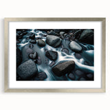 Framed wall art featuring a serene landscape with rocks, set in a silver frame with a mat, ideal for enhancing interior decor with nature-inspired elegance.