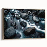 Framed canvas wall art featuring a serene landscape with rocks and natural elements, accented by a gold frame, ideal for home decor or office settings.
