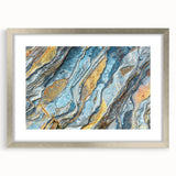 Framed wall art featuring a serene landscape design with rocky formations, presented in a silver frame with a mat, ideal for home decor.