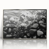 Framed acrylic wall art featuring a serene landscape with textured rocks, highlighted by a silver frame, perfect for enhancing modern home decor.