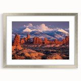 Framed wall art showcasing a serene landscape with rocks, set in a sleek silver frame with matting, perfect for modern home decor or office aesthetics.