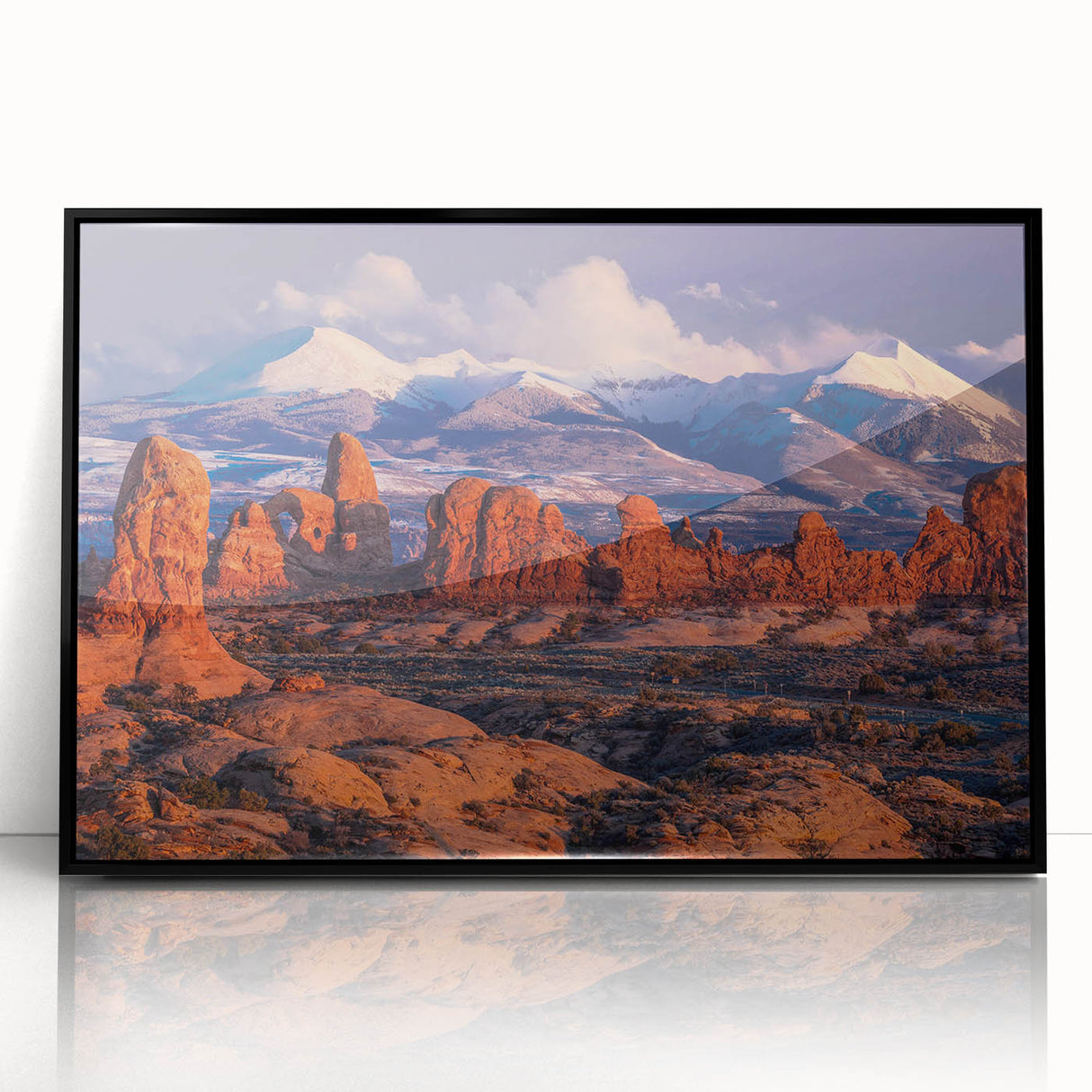 Framed acrylic wall art featuring a contemporary landscape design with textured rock formations, showcased in a sleek black frame, perfect for modern home decor.