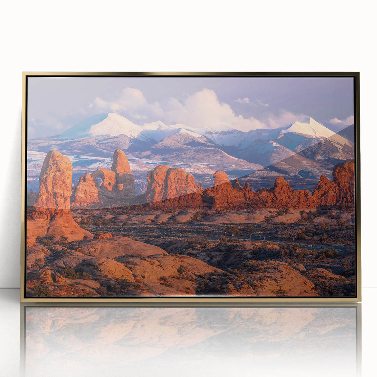 Framed acrylic wall art showcasing a modern landscape design with rocks, set in an elegant gold frame, ideal for contemporary home decor or office spaces.