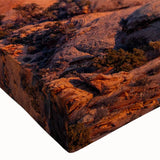 Close-up of a stretched canvas wall art featuring a vibrant landscape design with textured rocks and earthy tones, perfect for modern home decor.