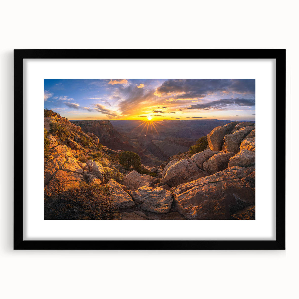 Framed wall art featuring a modern landscape design with rocks in earthy tones, presented in a sleek black frame with a white mat, ideal for contemporary decor.