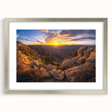 Framed landscape wall art featuring a rocky terrain design with a silver mat and frame, ideal for modern home decor, highlighting natural textures and colors.