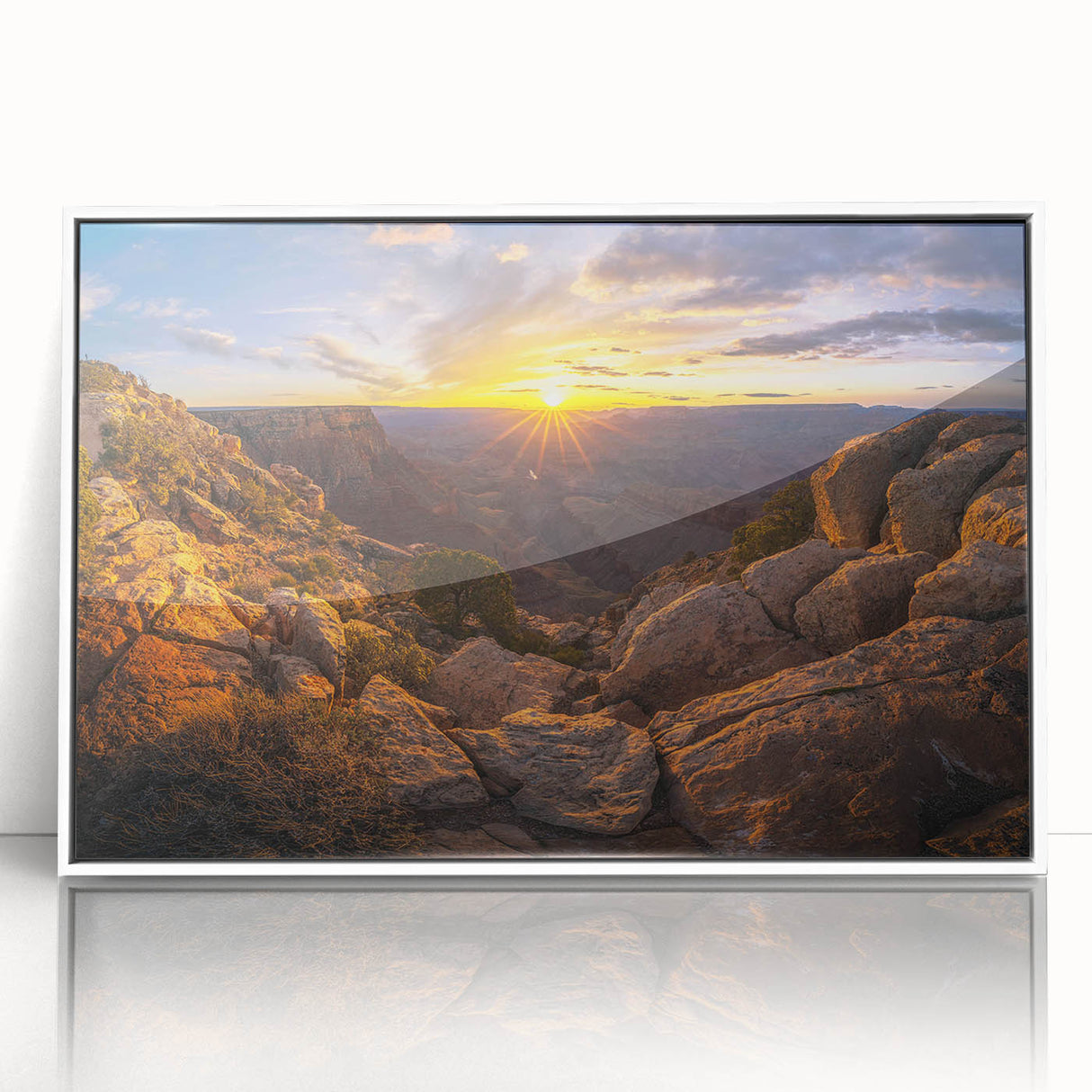 Framed acrylic wall art featuring a serene landscape with rocks, showcasing earthy tones and a modern white frame, perfect for contemporary home decor.