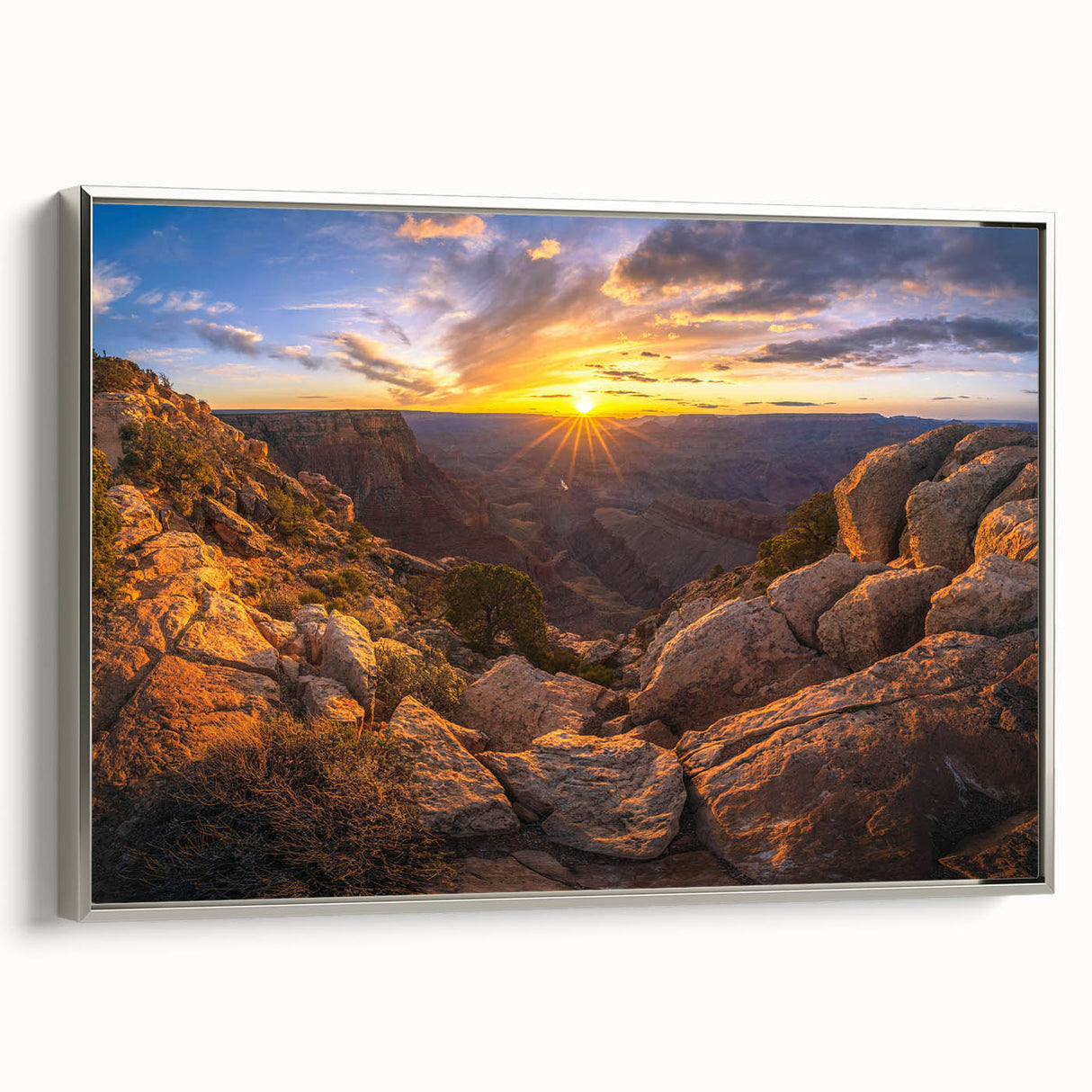 Framed canvas wall art featuring a serene landscape with textured rocks and soft earth tones, elegantly displayed with a silver frame, ideal for modern decor.