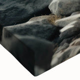 Close-up of a stretched canvas wall art piece showcasing a vibrant landscape design with rocky formations, ideal for enhancing home decor aesthetics.