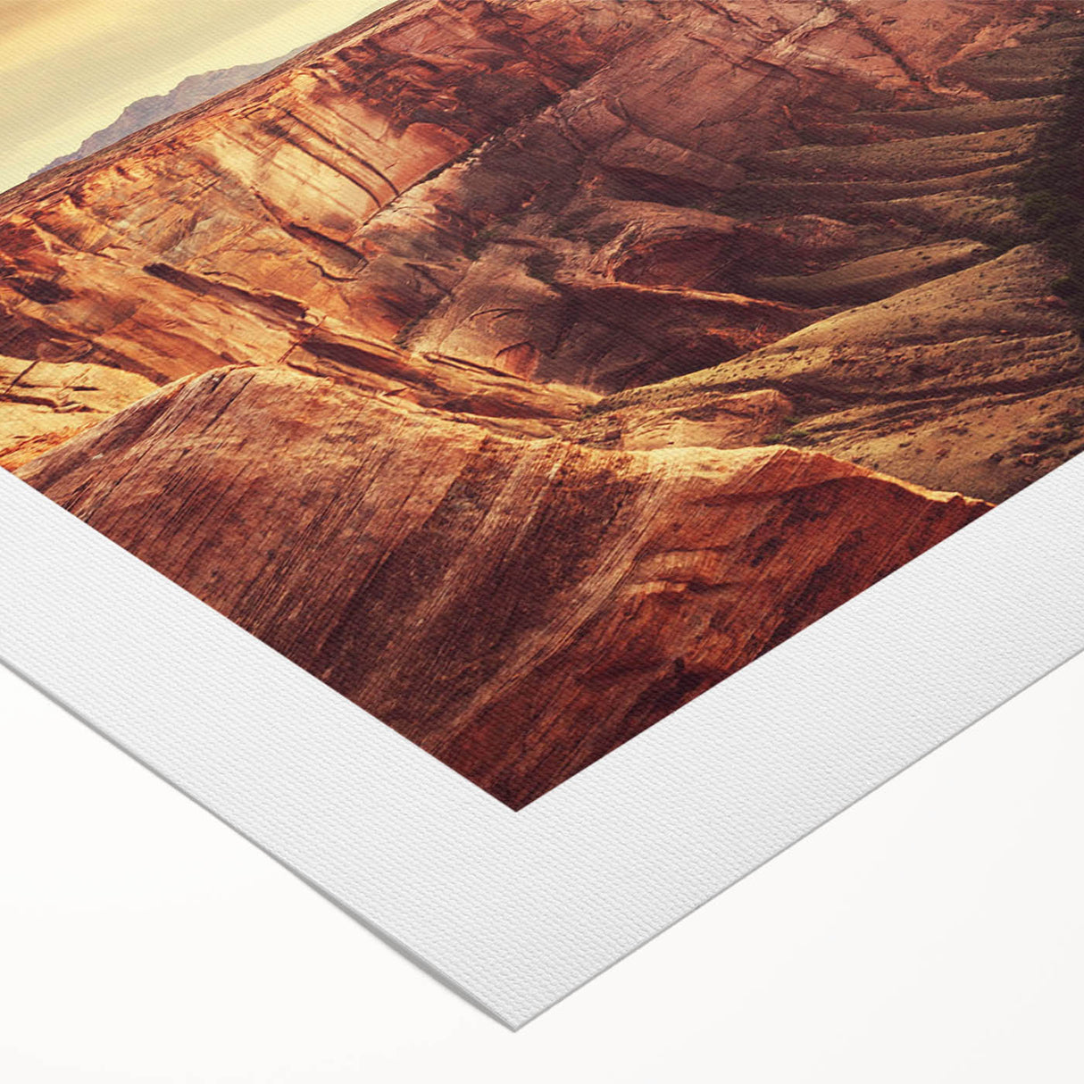 Rolled canvas artwork showcasing a vibrant landscape of rugged rocks and blue skies, ideal for home decor, presented in a protective cardboard tube.