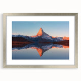 Framed wall art showcasing a tranquil landscape with intricate rock formations, presented in a sleek silver frame with a mat, ideal for modern home decor.