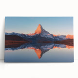 Stretched canvas artwork showcasing an abstract landscape with vibrant colors and textured rocks, elegantly leaning against a wall in a modern interior setting.