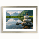Framed wall art showcasing a serene landscape with gray rocks and soft blue hues, featuring a silver frame and matting, perfect for modern home decor.
