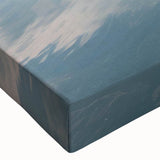 Close-up of a stretched canvas artwork showcasing a vibrant landscape with rugged rocks and textured details, perfect for enhancing any modern decor.