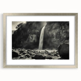 Framed wall art showcasing a serene landscape of rocks and mountains, elegantly displayed with a silver matting, perfect for modern home decor.