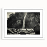 Framed wall art featuring a serene landscape of rocks against a soft blue sky, with a white mat and sleek frame, perfect for modern home decor.