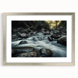 Framed wall art showcasing an intricate landscape of rocks in earthy tones, set in a sleek silver frame with a white mat, perfect for modern decor.