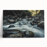 Stretched canvas artwork showcasing a vibrant landscape design with colorful rocks, leaning against a minimalist wall, perfect for modern home decor.