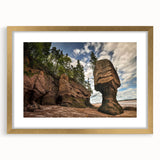 Framed wall art featuring a stunning landscape design with rocks, set in an elegant gold frame and matting, perfect for enhancing modern home decor.