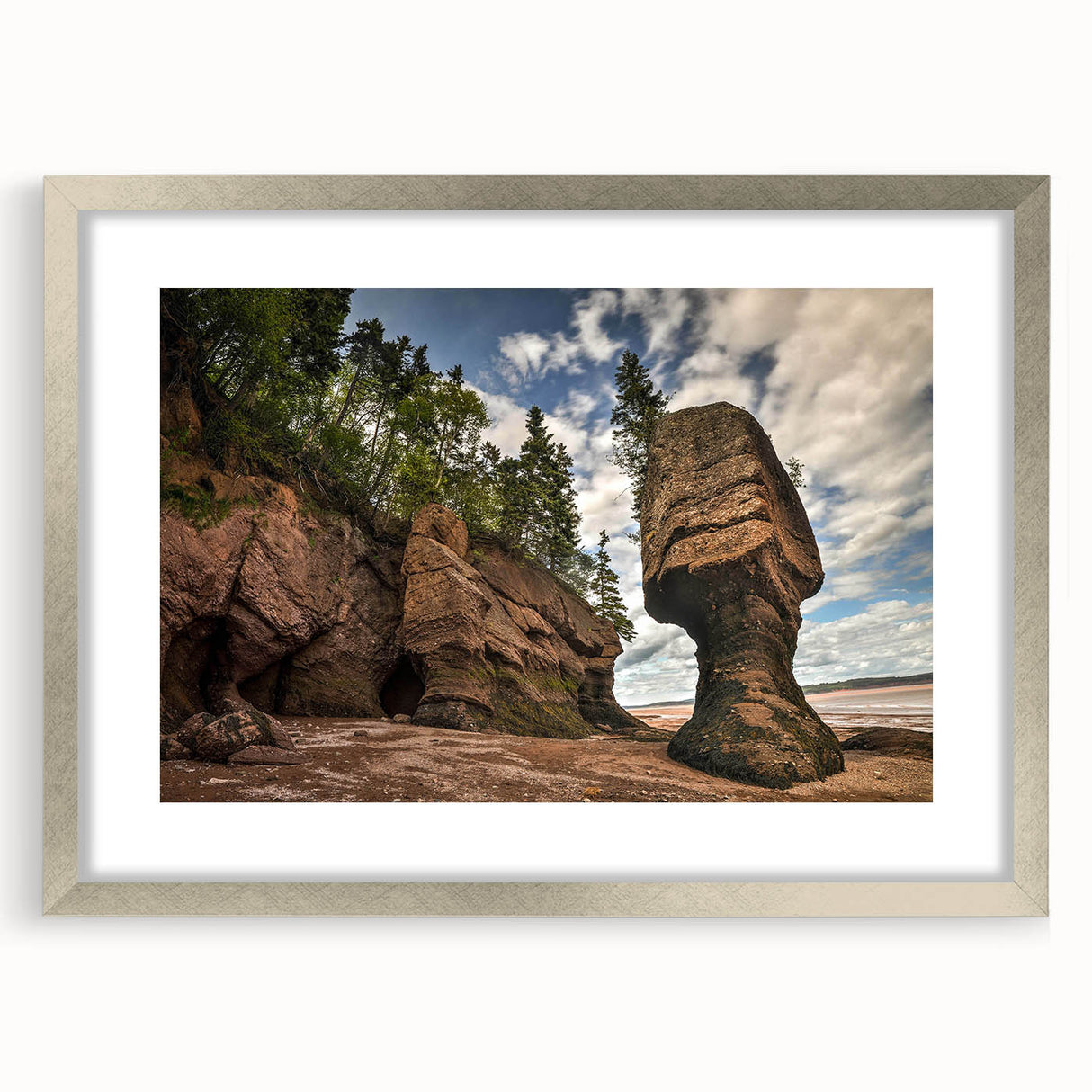 Framed landscape wall art showcasing a serene rocky terrain with soft hues, elegantly matted and finished in a sleek silver frame, perfect for home decor.