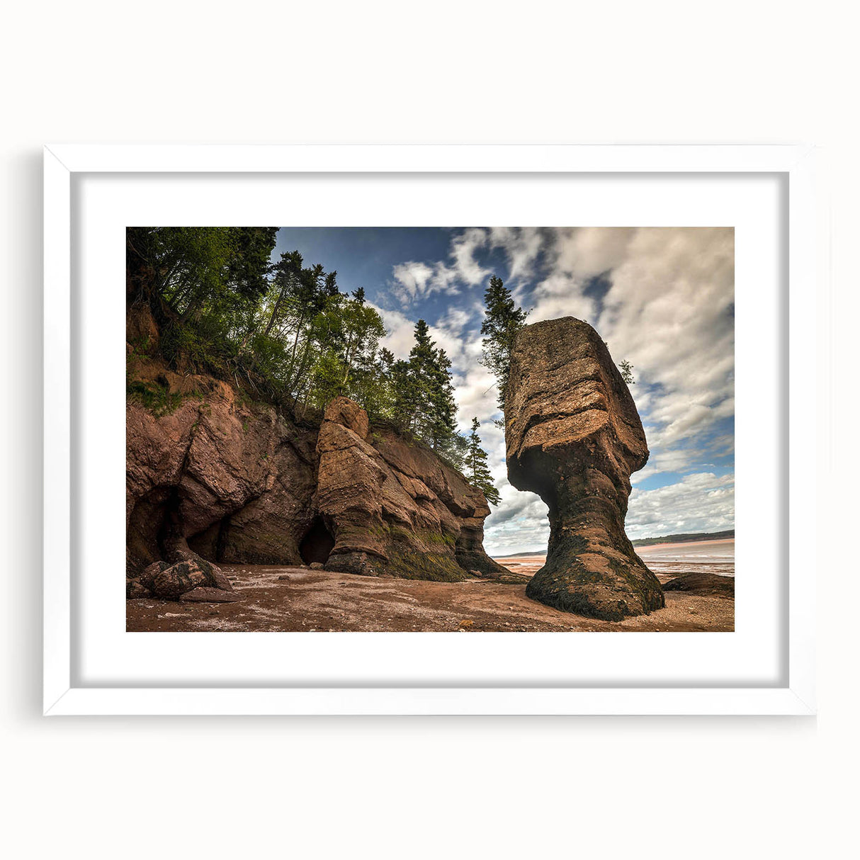 Framed wall art featuring a serene landscape design with rocks and greenery, set in a sleek white frame and mat, perfect for home decor enhancement.