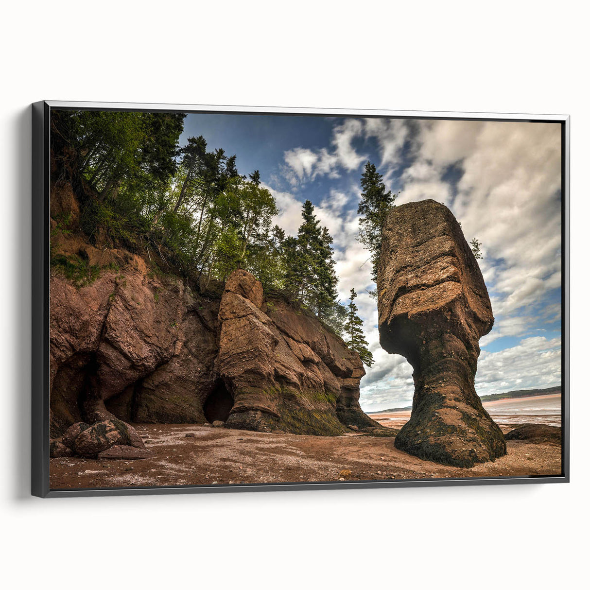 Framed canvas wall art showcasing a modern landscape design with prominent rock formations, featuring a sleek black frame and side profile view, ideal for contemporary decor.