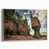 Framed canvas wall art showcasing a serene landscape with rocky formations, featuring a silver frame. Ideal for modern home decor, adding elegance to any room.