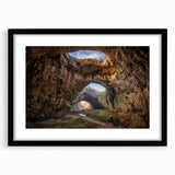 Framed landscape wall art design featuring rocky terrain in muted earth tones, elegantly displayed in a sleek black frame with a white mat. Perfect for modern home decor.