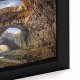 Close-up of a framed canvas wall art piece showcasing a vibrant landscape design featuring rugged rocks and earthy tones, perfect for home decor enhancement.