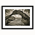 Framed wall art depicting an abstract landscape with rocks, featuring a sleek black frame and white matting, perfect for modern home decor.