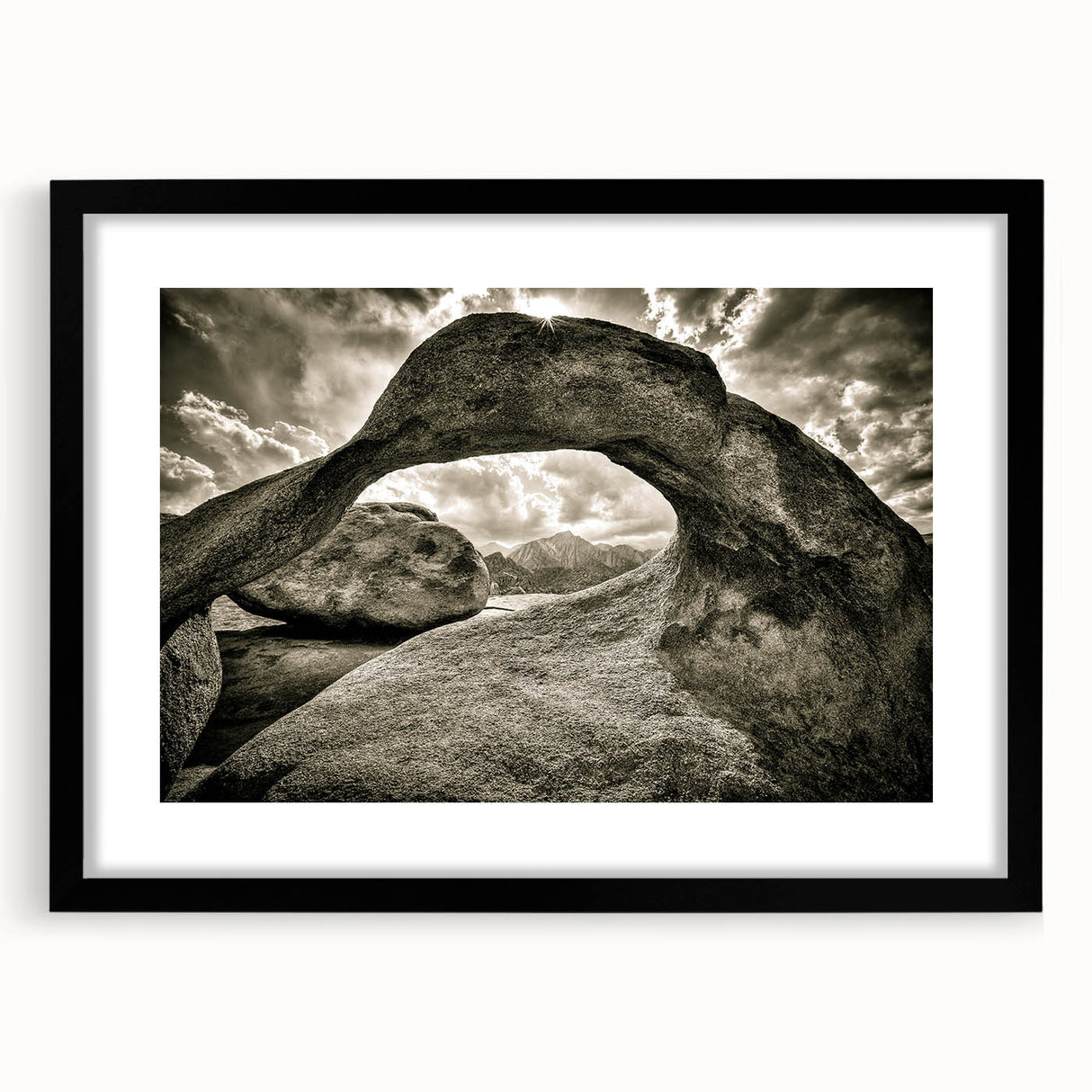 Framed wall art depicting an abstract landscape with rocks, featuring a sleek black frame and white matting, perfect for modern home decor.