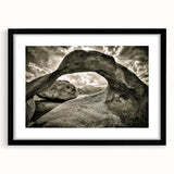 Framed wall art depicting an abstract landscape with rocks, featuring a sleek black frame and white matting, perfect for modern home decor.
