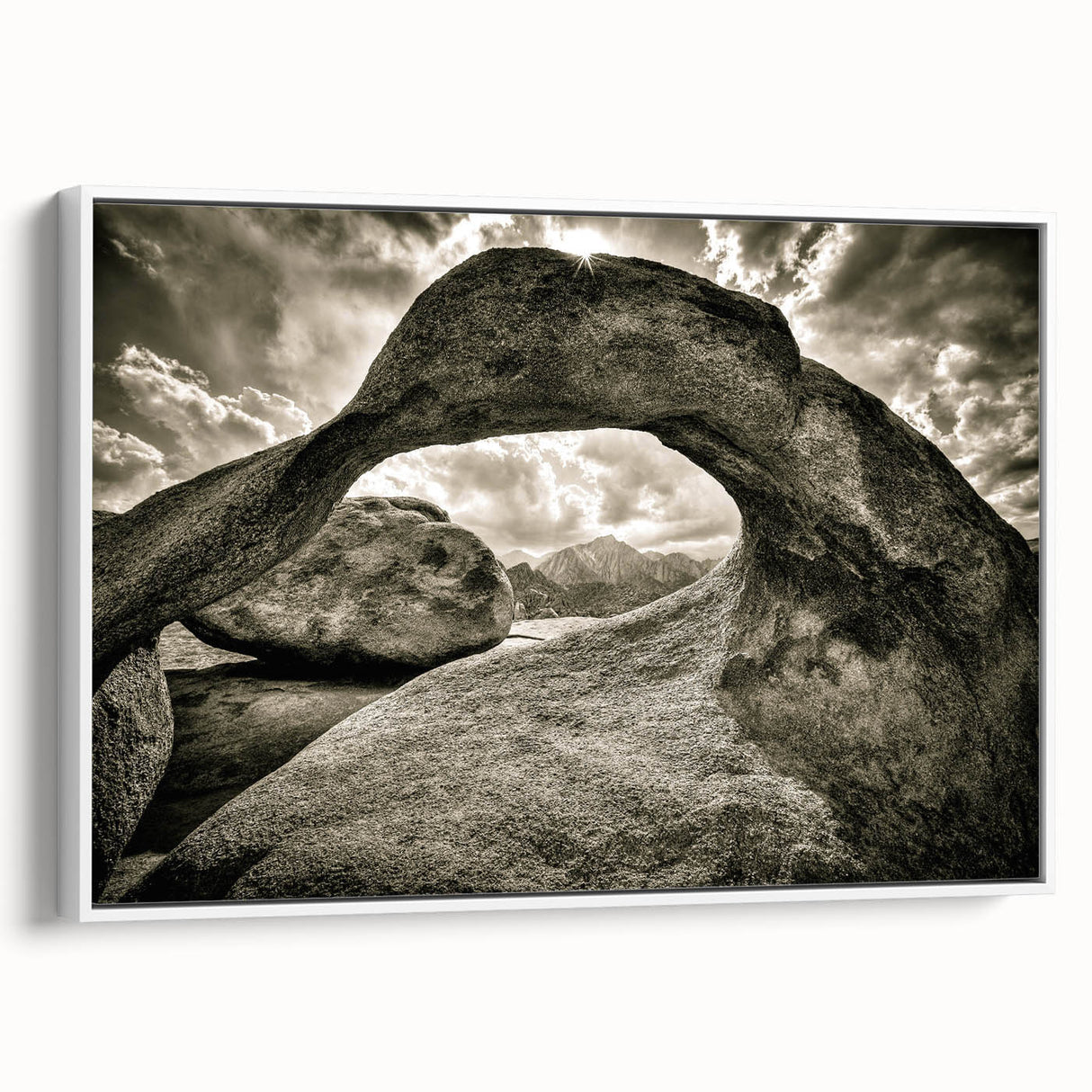 Framed canvas wall art showcasing a serene landscape with rocks and natural elements, accented by a white frame, perfect for home decor and interior design inspiration.