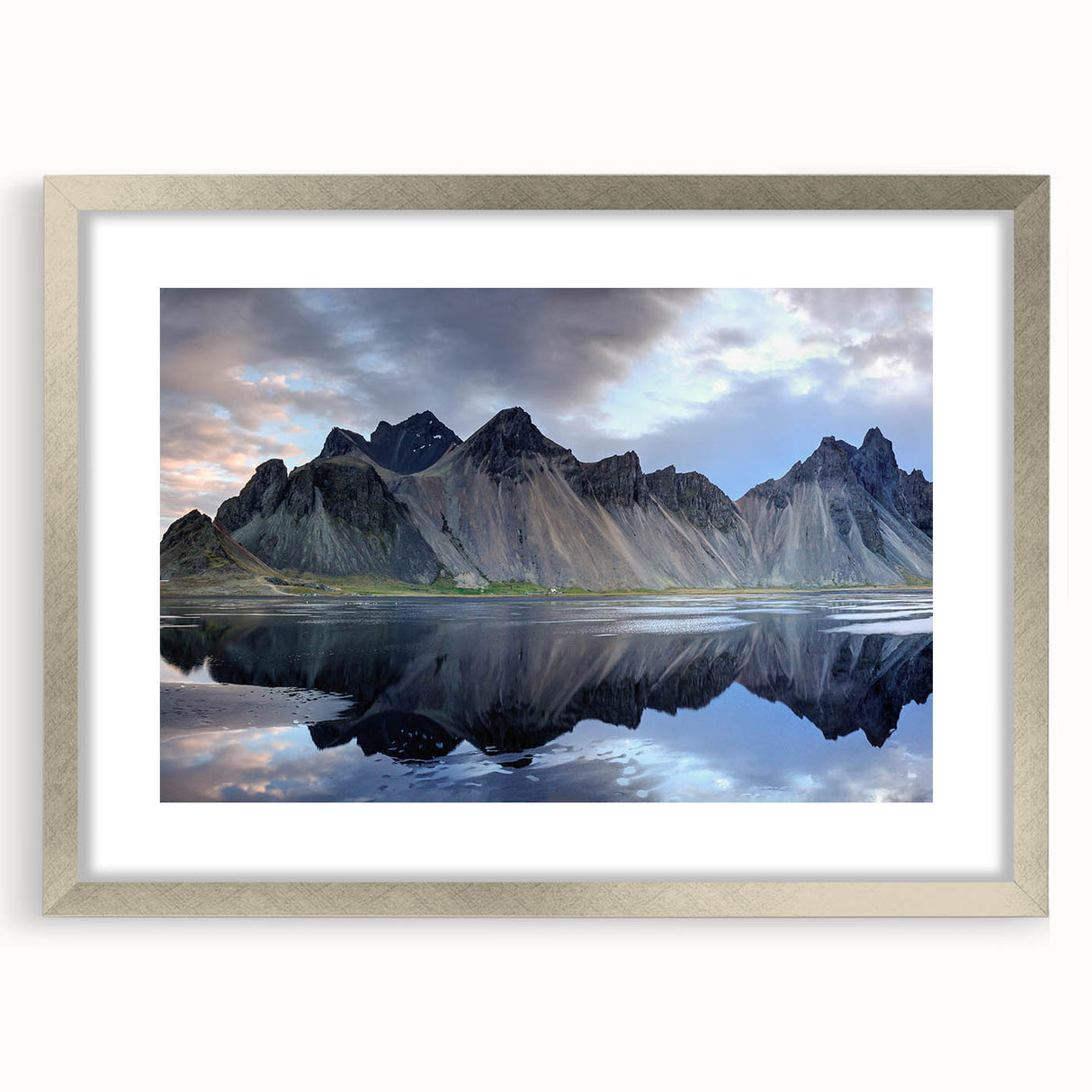 Framed wall art featuring a stunning landscape design with rocks, surrounded by a sleek silver frame and mat, ideal for enhancing home decor aesthetics.