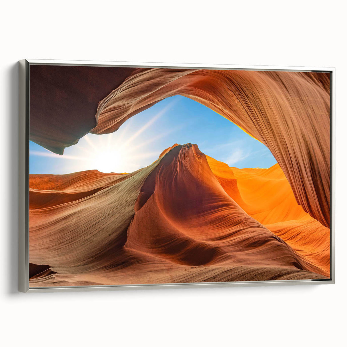 Framed canvas wall art featuring a stunning landscape design with rocky formations and vibrant colors, presented with a sleek silver frame, ideal for modern decor.