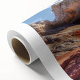 Rolled canvas art print showcasing a serene landscape with textured rocks and vibrant colors, ideal for home decor. Packaged securely in a cardboard tube for safe delivery.