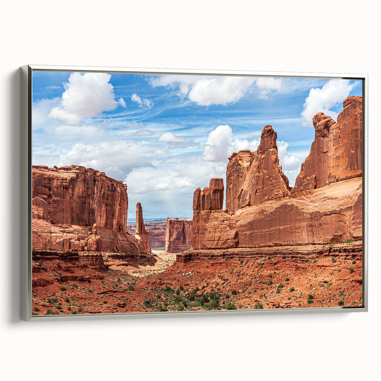 Framed canvas wall art showcasing a serene landscape with rocks and natural elements, accented with a silver frame, perfect for contemporary home decor.