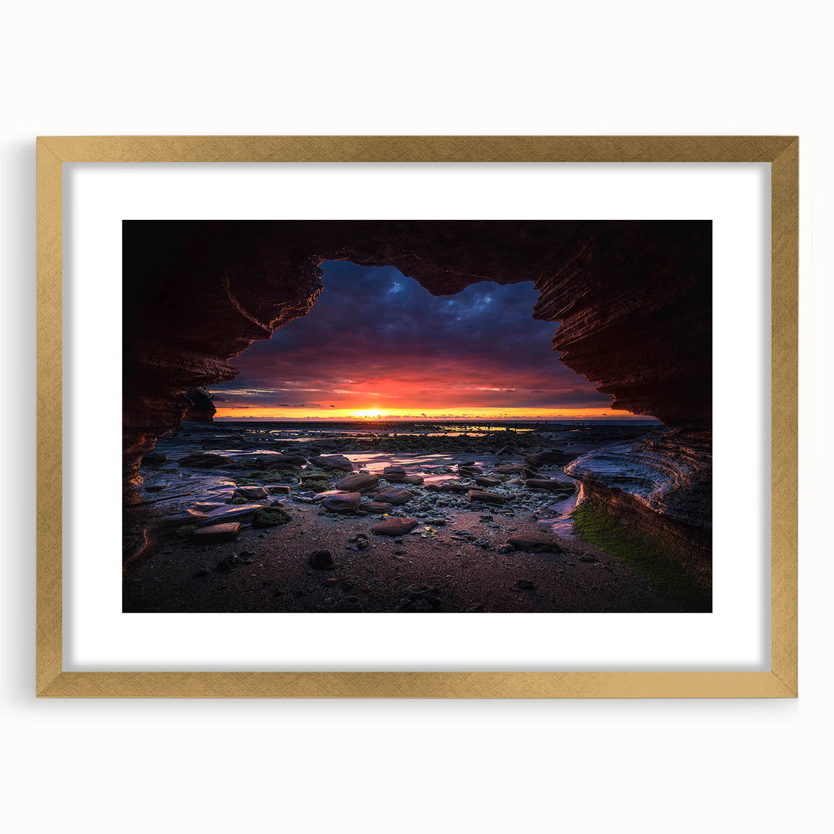 Framed landscape wall art featuring a serene rock design, elegantly matted and showcased in a gold frame, perfect for enhancing modern home decor.