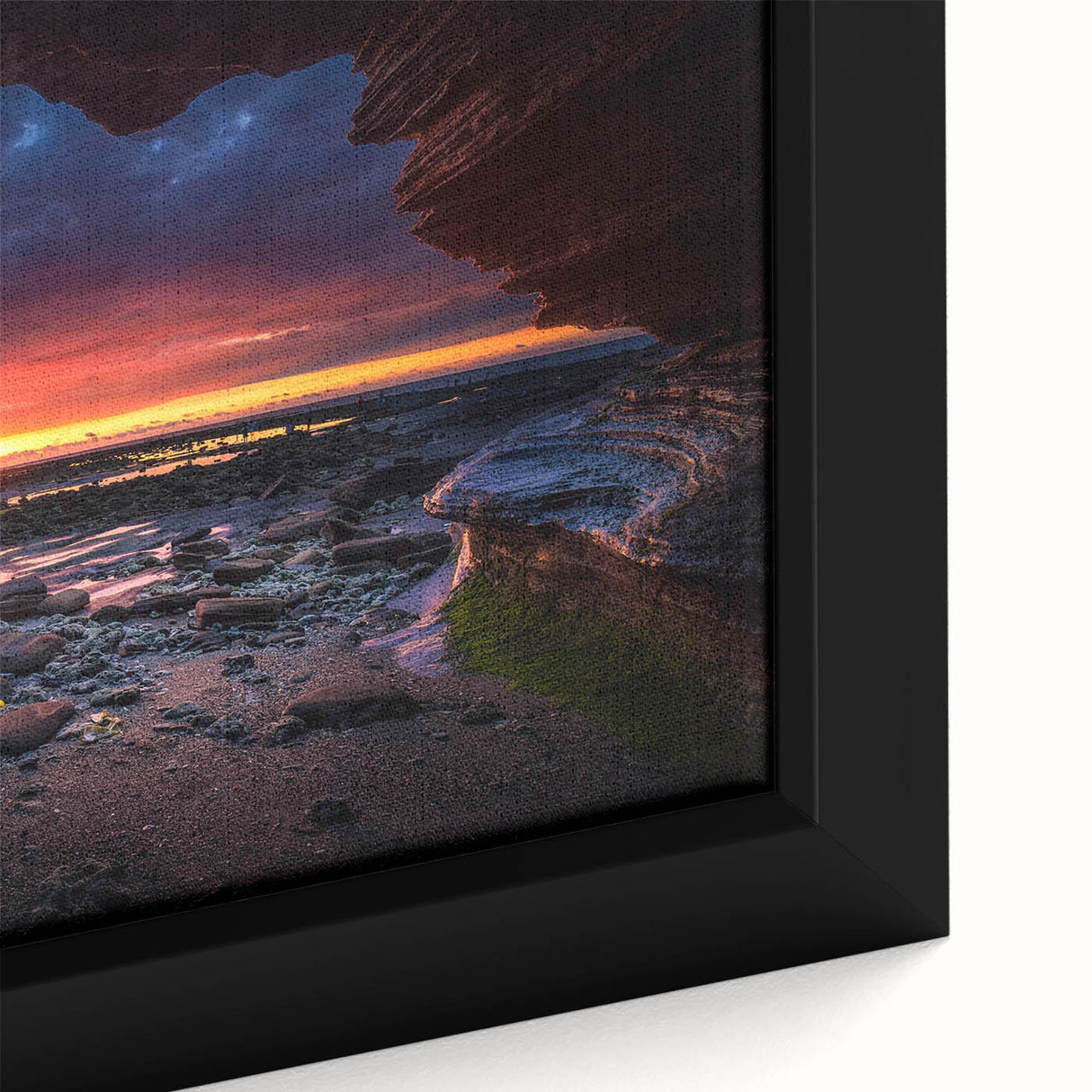 Close-up of a framed canvas artwork showcasing a vibrant landscape design featuring rocky formations and earthy colors, ideal for modern home decor.