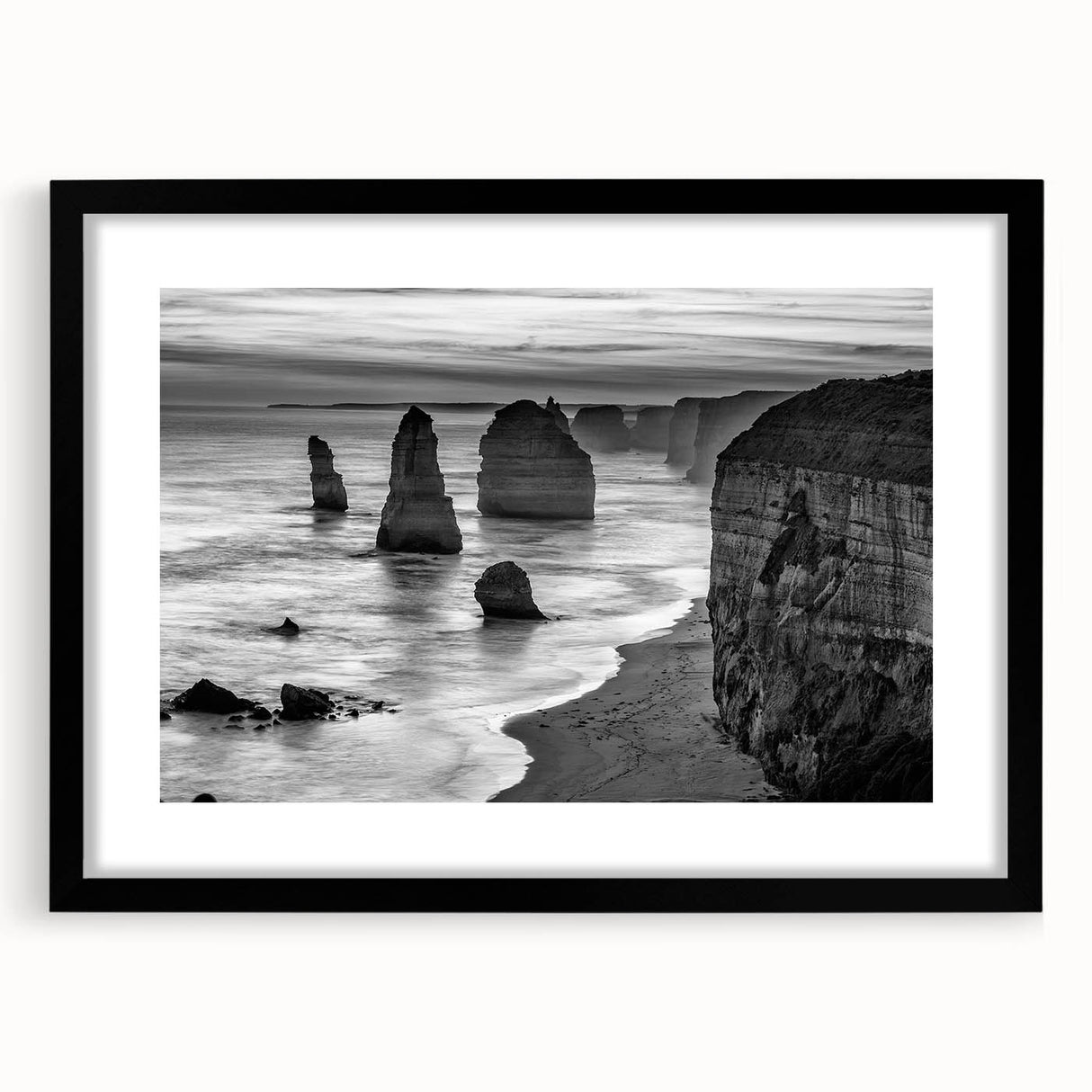 Framed wall art collection showcasing a serene seascape design, featuring calming blue and white hues, with a sleek black frame and mat, perfect for coastal decor.