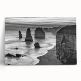 Stretched canvas wall art collection showcasing vibrant seascapes and landscapes, leaning against a neutral wall, enhancing modern interior decor aesthetics.