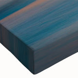 Close-up of a stretched canvas artwork showcasing a vibrant seascape design, featuring dynamic waves and a serene color palette, perfect for coastal home decor.